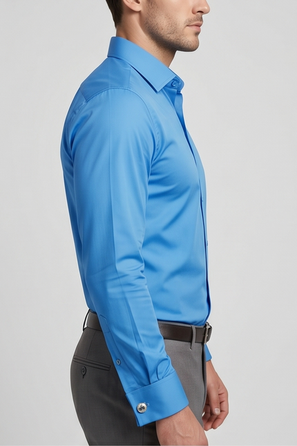 Man wearing a blue dress shirt and gray pants on a light gray background
