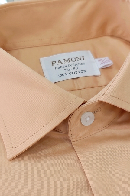 Close-up of a beige shirt collar with a Pamoni label.