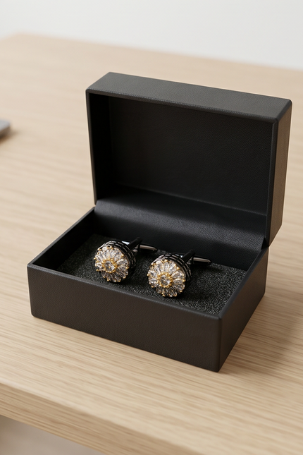 Pair of cufflinks in a black box on a wooden surface