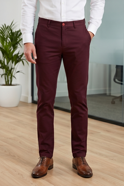 Person wearing maroon pants and brown shoes in an office setting