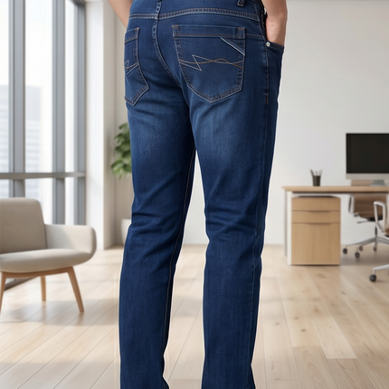 Person wearing blue jeans in a modern office setting