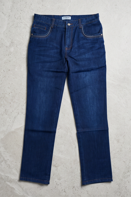Pair of blue jeans on a light gray surface