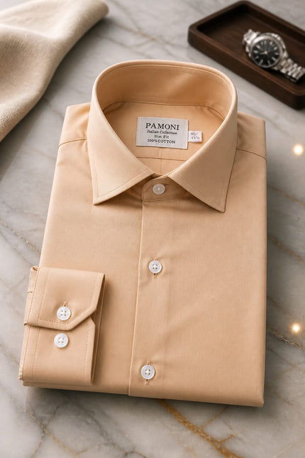 Folded beige shirt with 'Pamoni' label on a marble surface