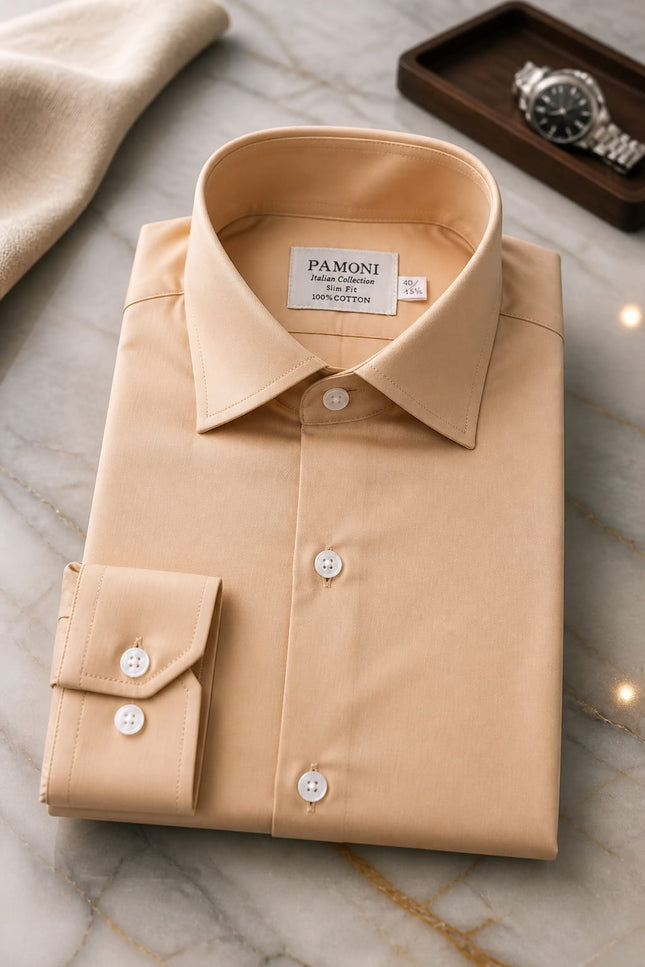 Folded beige shirt with 'Pamoni' label on a marble surface